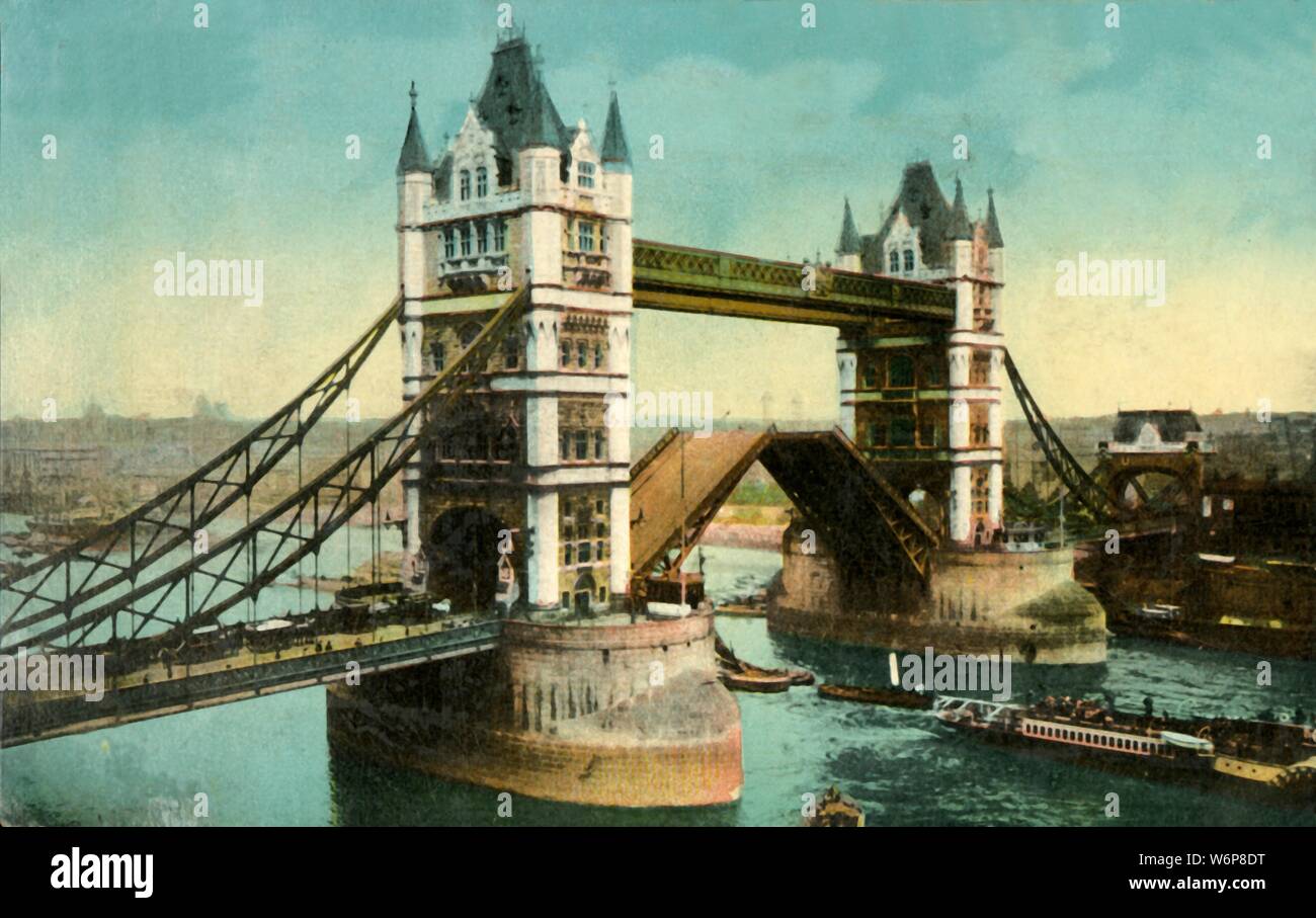 Tower Bridge, London, c1910. View of Tower Bridge with bascules open, and the River Thames. The construction of the bridge was begun in 1881 to designs by Sir Horace Jones and it opened in 1894. It was designed so that the central section could be raised to allow the passage of ships to and from the busy wharves of London. Postcard. Stock Photo