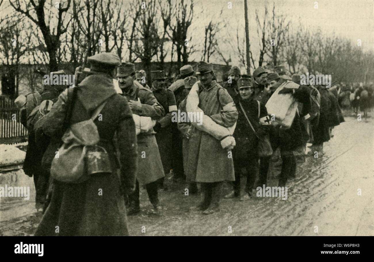 Austrian prisoners, Przemysl, March 1915, (c1920). 'After the Russian Capture of Przemysl, March 22, 1915: Austrian prisoners preparing for their sixty-mile march to Lemberg'. Austro-Hungarian forces surrendered to the Russians at the fortress of Przemysl (now in south-eastern Poland). From &quot;The Great World War - A History&quot; Volume III, edited by Frank A Mumby. [The Gresham Publishing Company Ltd, London, c1920] Stock Photo