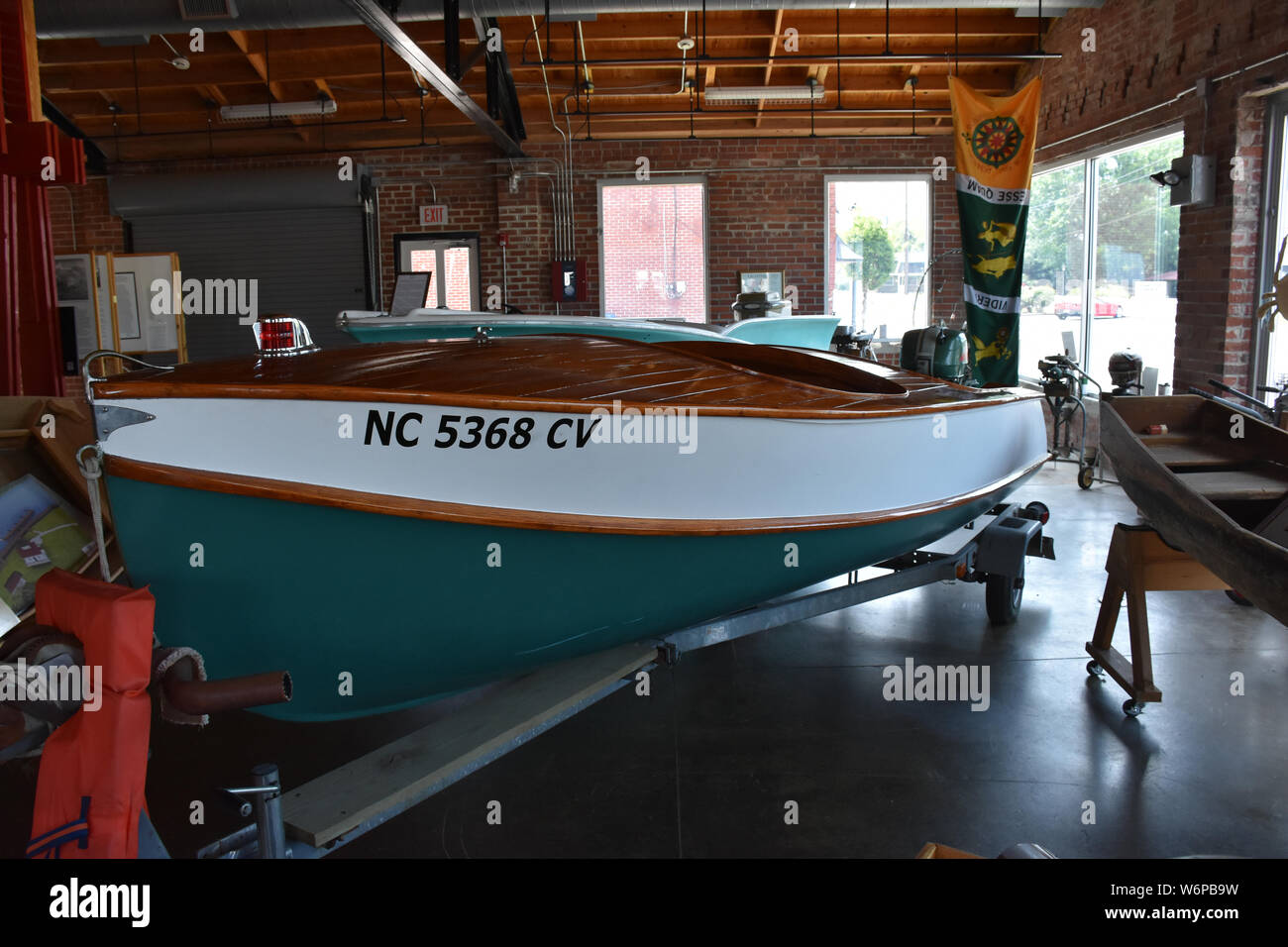 An antique wooden boat with outboard motor in a museum in Plymouth