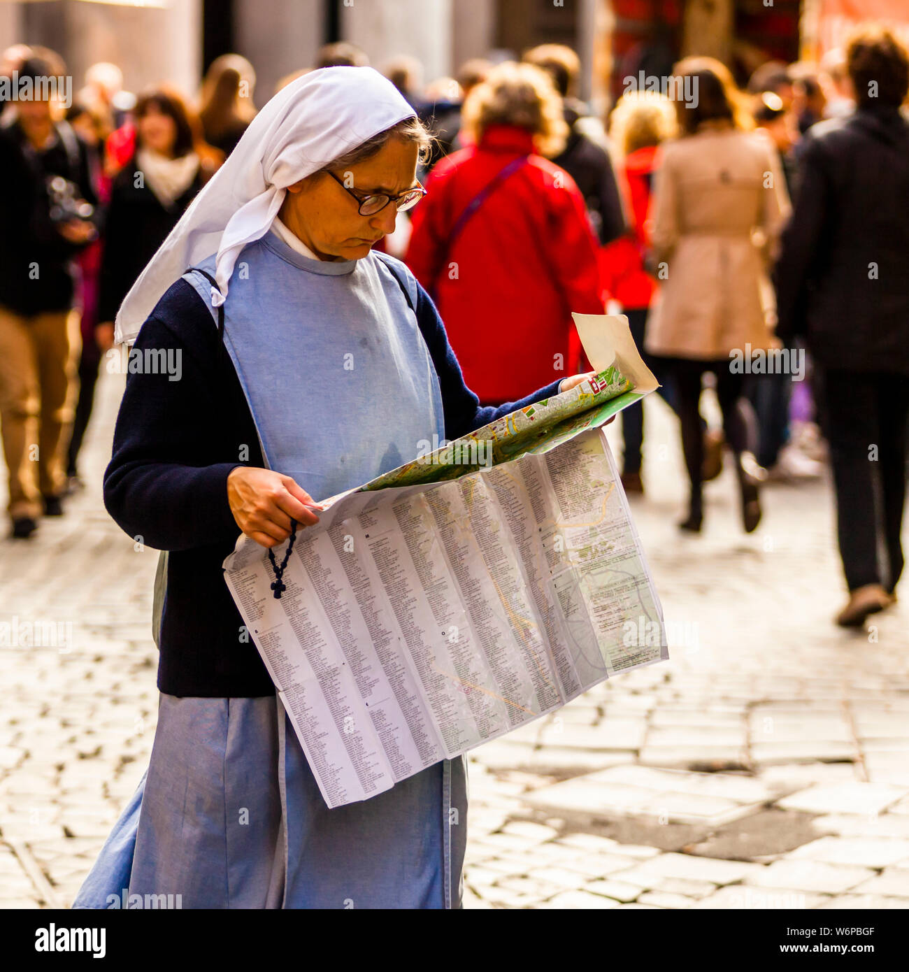 Nun with city map in Roma, Italy Stock Photo