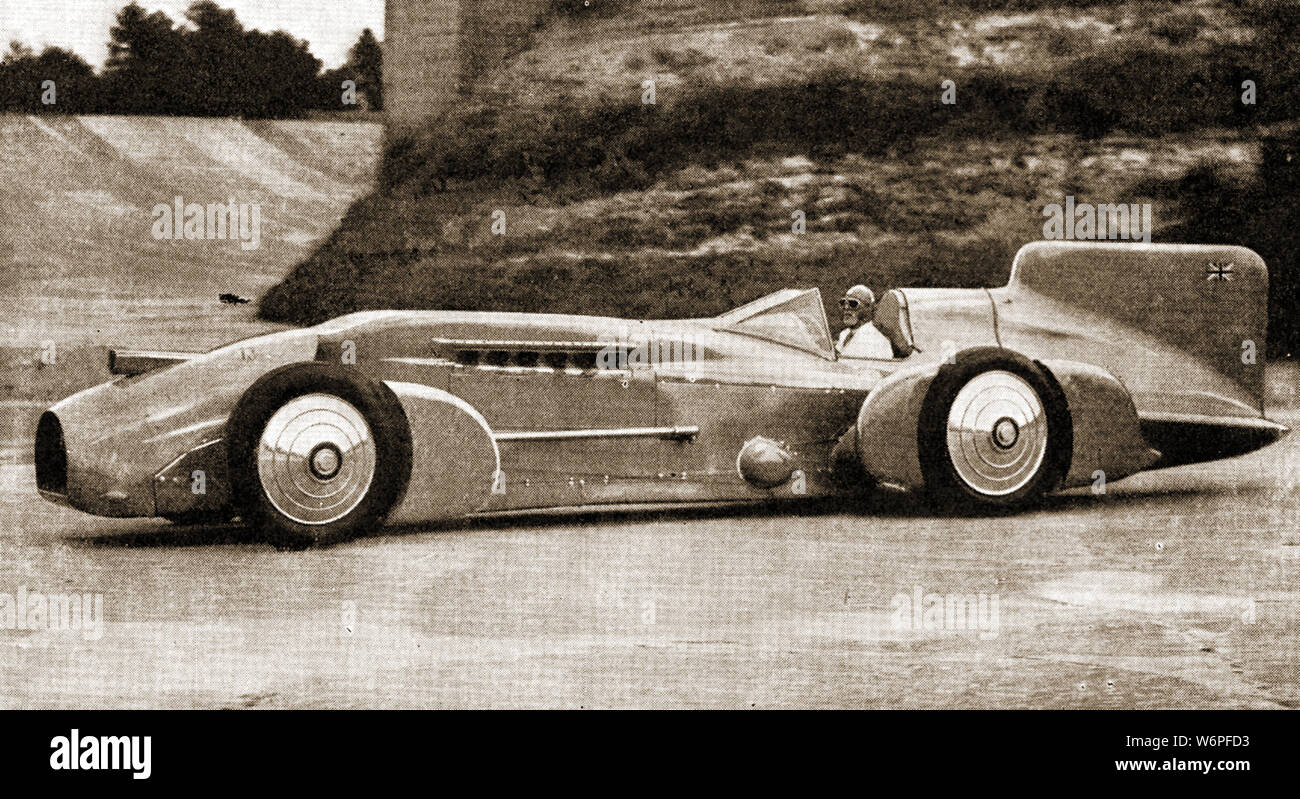 Sir Malcolm Campbell demonstrating the 'Bluebird' car to crowds at Brooklands circuit UK Stock Photo