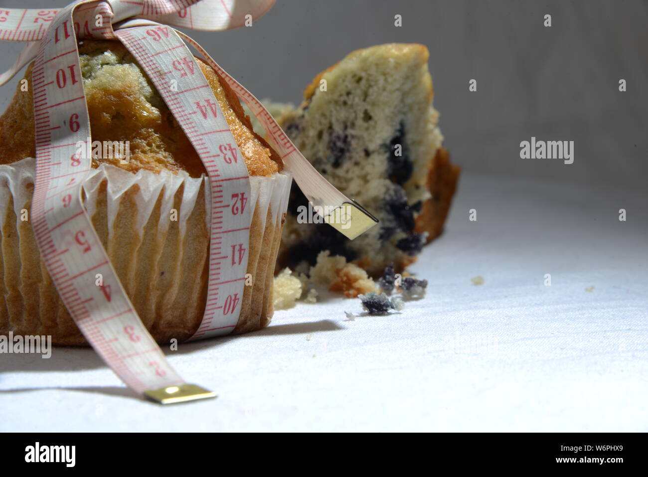 cup cake and cakes and loosing weight biscuit getting fat and sizing symbol of  weight meter cake from close meaningful photo junk food Stock Photo