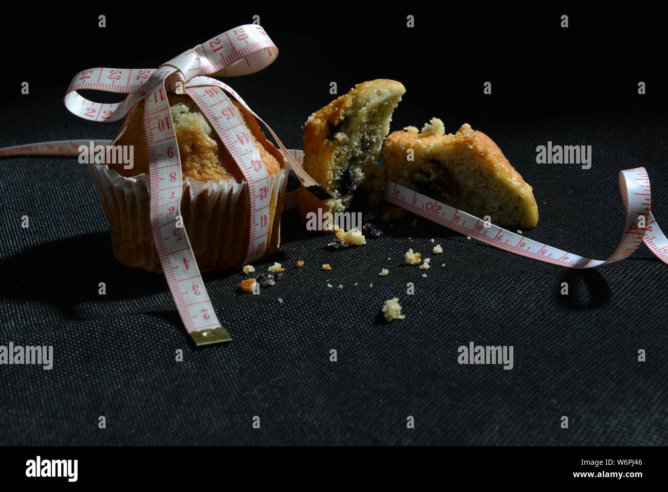 cup cake and cakes and loosing weight biscuit getting fat and sizing symbol of  weight meter cake from close meaningful photo junk food Stock Photo
