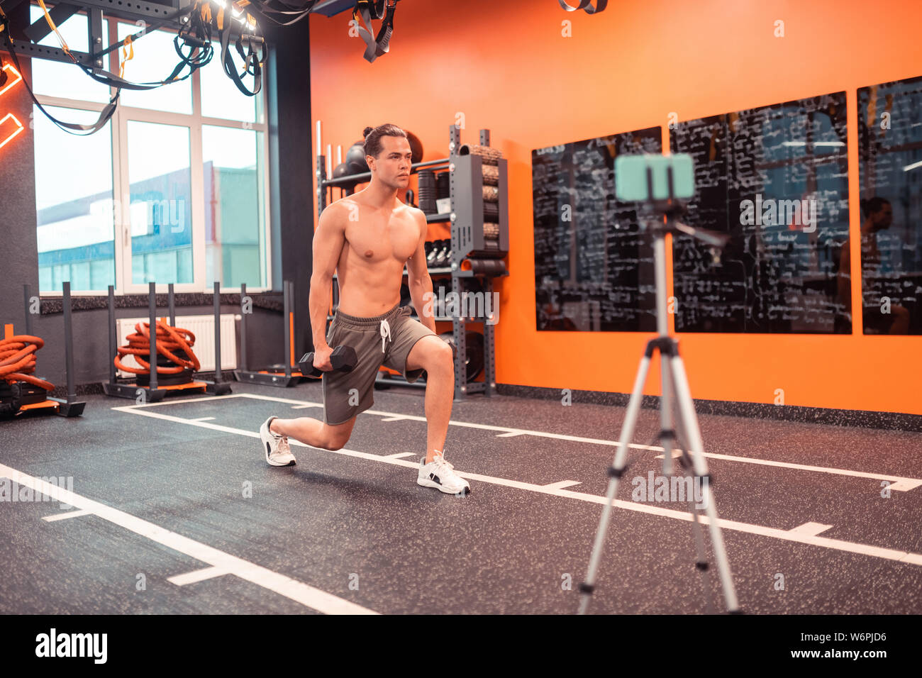 Well Build Nice well built man showing the exercise with dumbells Stock Photo - Alamy