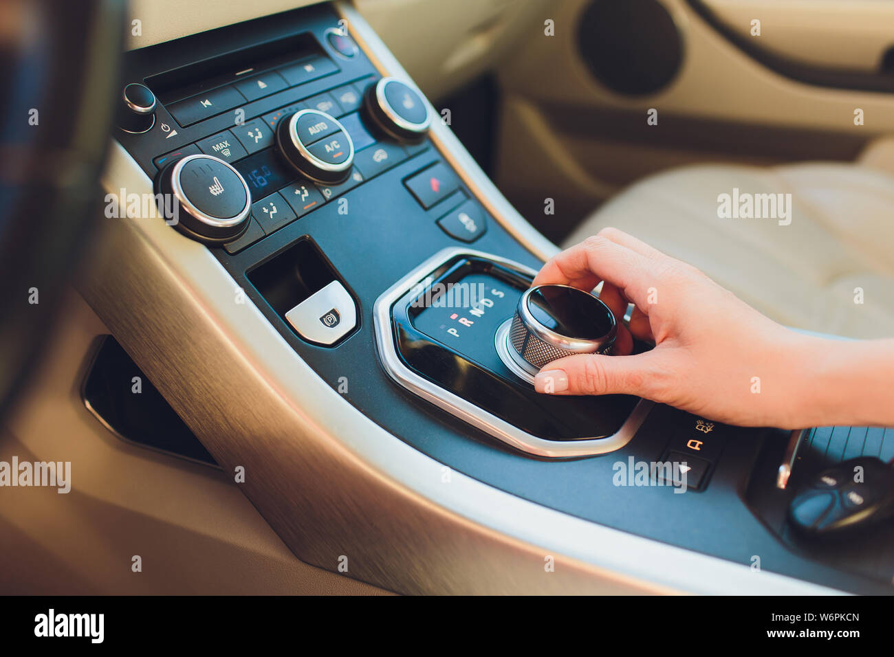 Close up Young woman hand on automatic gear shift, shifting gearbox in