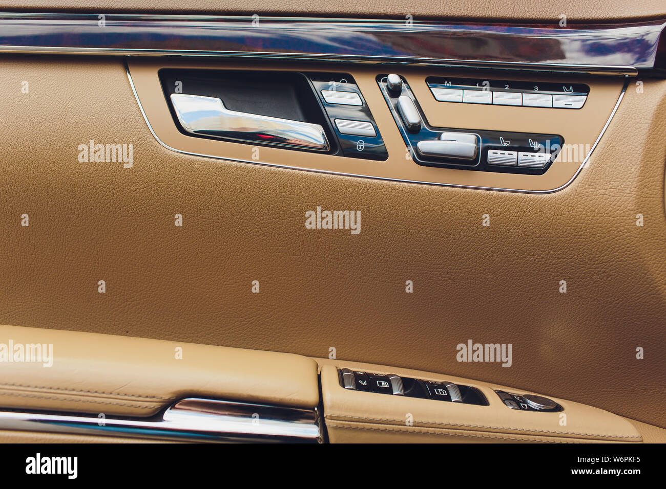 Control panel in the car door. Car door handle with adjustment knobs
