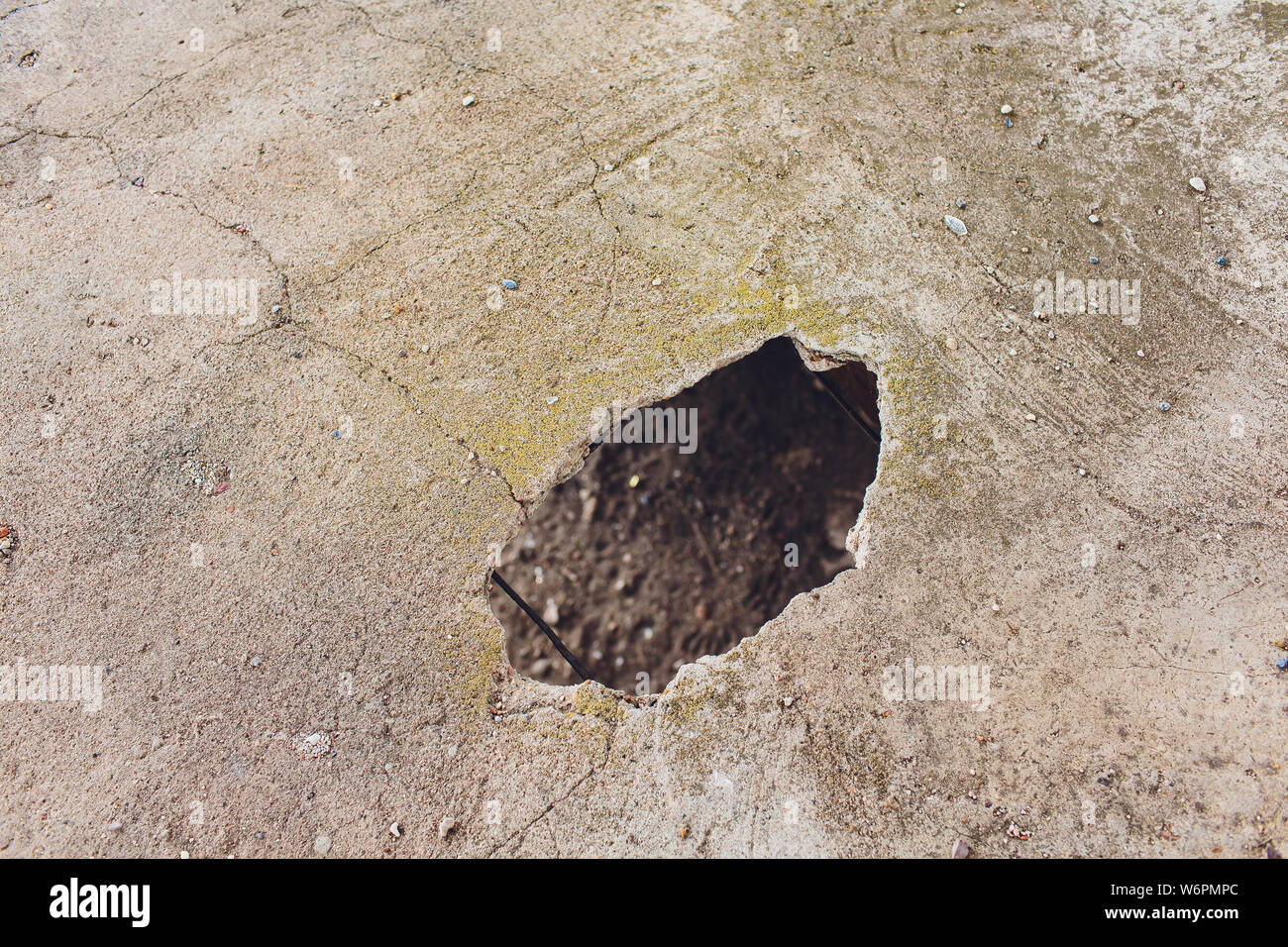 Cracks holes on the cement wall Caused by drilling To put the plumbing