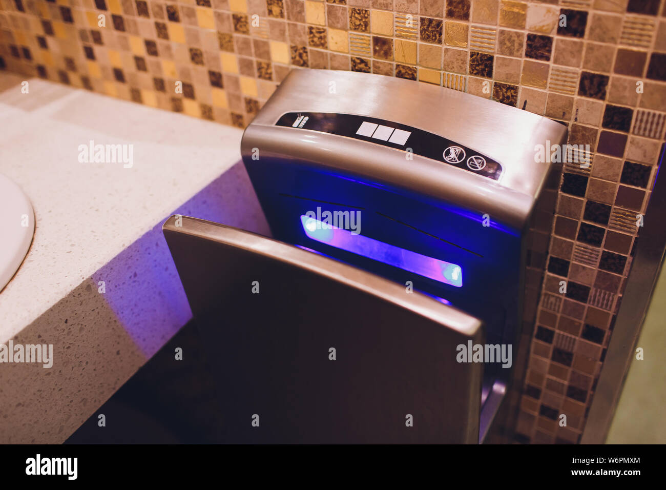Modern vertical hand dryer in public restroom WC Stock Photo Alamy
