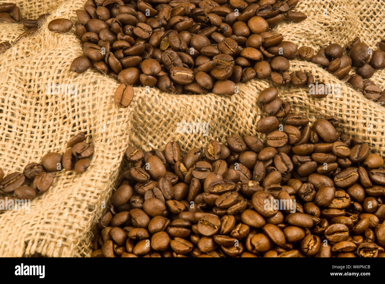 Shot of a sack of roasted coffee beans ready to be ground for a fresh coffee experience. Stock Photo