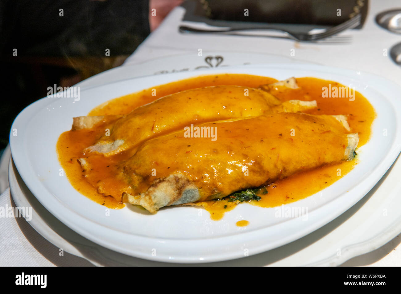 Vegetarian stuffed pasta noodle with red sauce served on top Stock Photo
