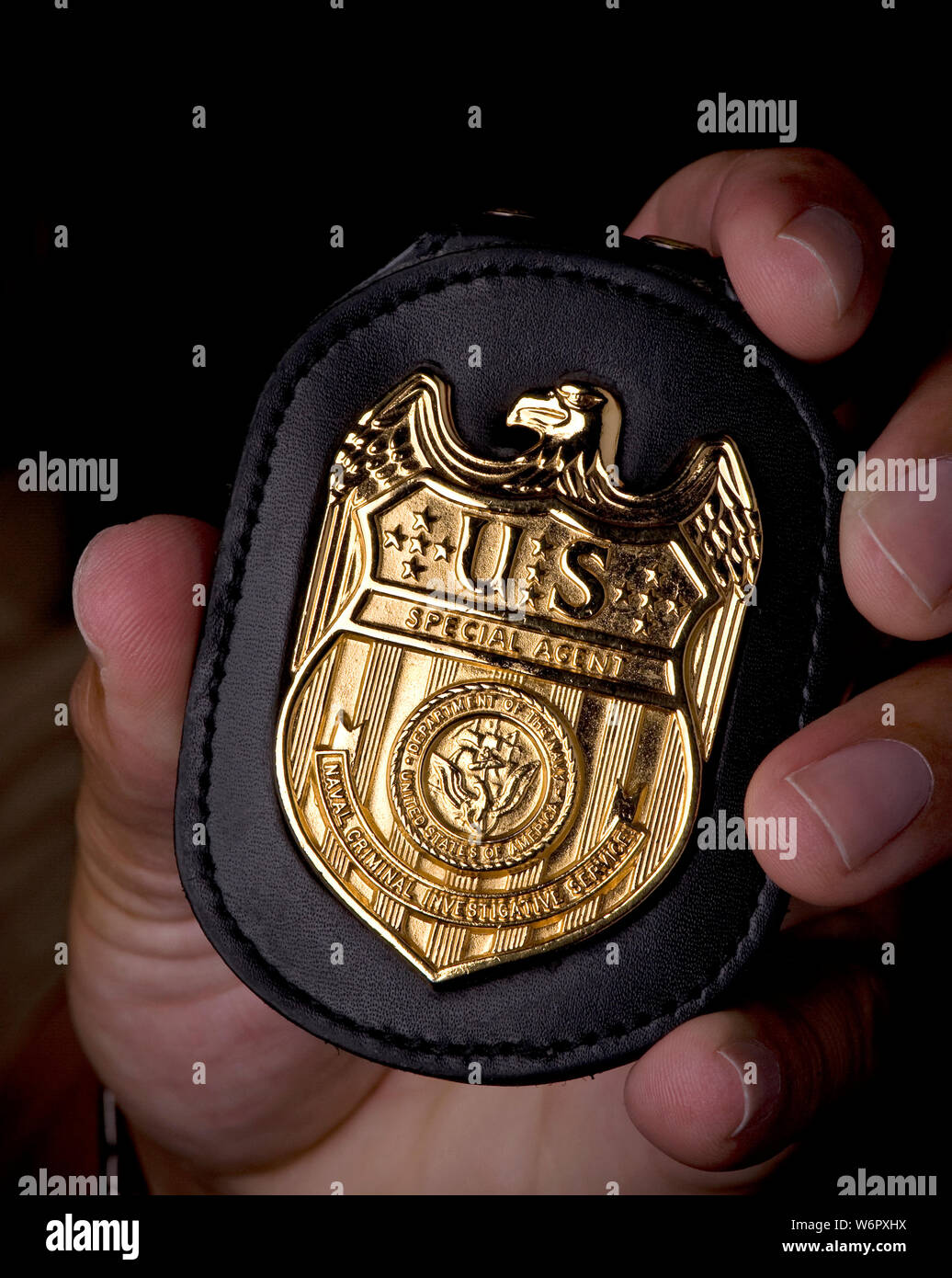 A close-up of an official NCIS Special Agent’s identification badge. NCIS (the Naval Criminal Investigative Service) is the US Navy's primary law enforcement and counterintelligence force. The agency works alongside local, state, and federal law enforcement as well as foreign agencies to counter and investigate serious crimes such as terrorism and espionage as well as dealing with common felonies involving Department of the Navy personnel. US Navy photo by Mass Communication Specialist 1st Class R. Jason Brunson. Stock Photo