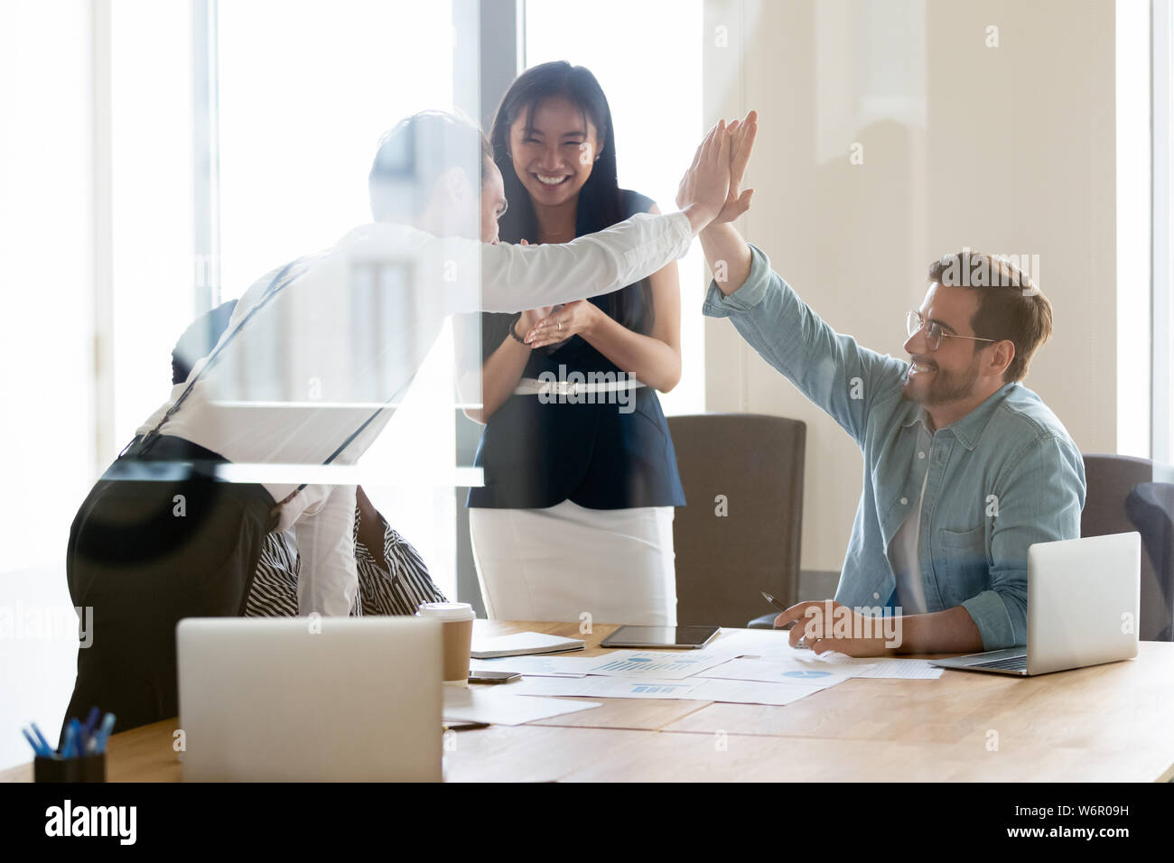 Happy successful business men giving high five at team meeting Stock ...