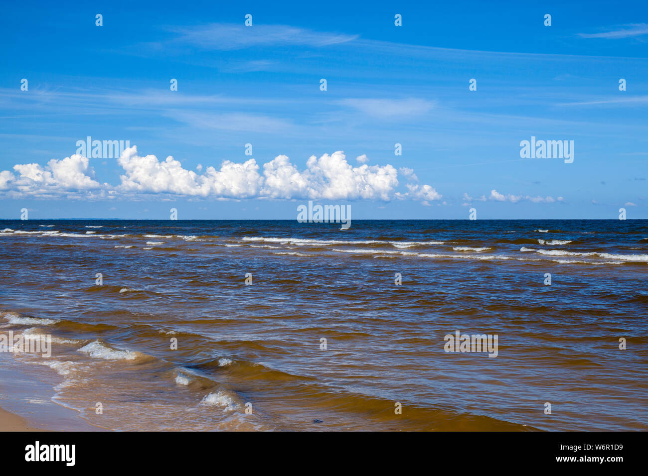 Natural sky and sea background, Gulf of Riga, the brown tint to the water due to algal bloom Stock Photo