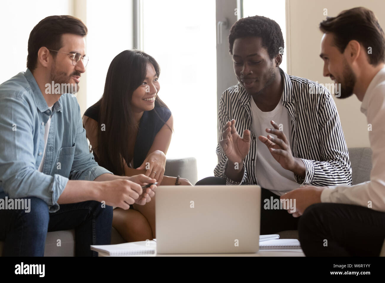 Multiethnic business team listen to african mentor explain online strategy Stock Photo