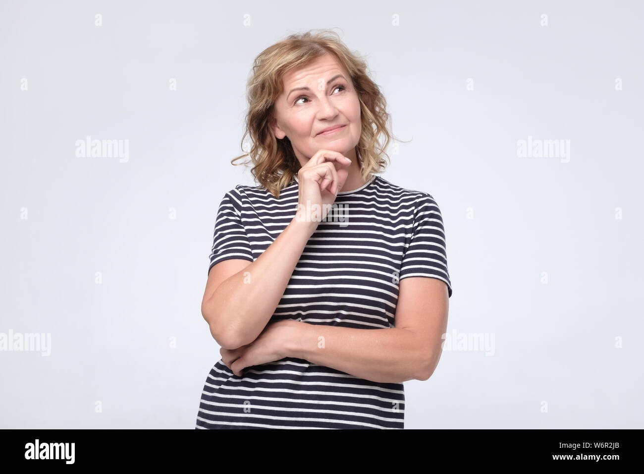 Woman thinking about something making plans about future. Stock Photo