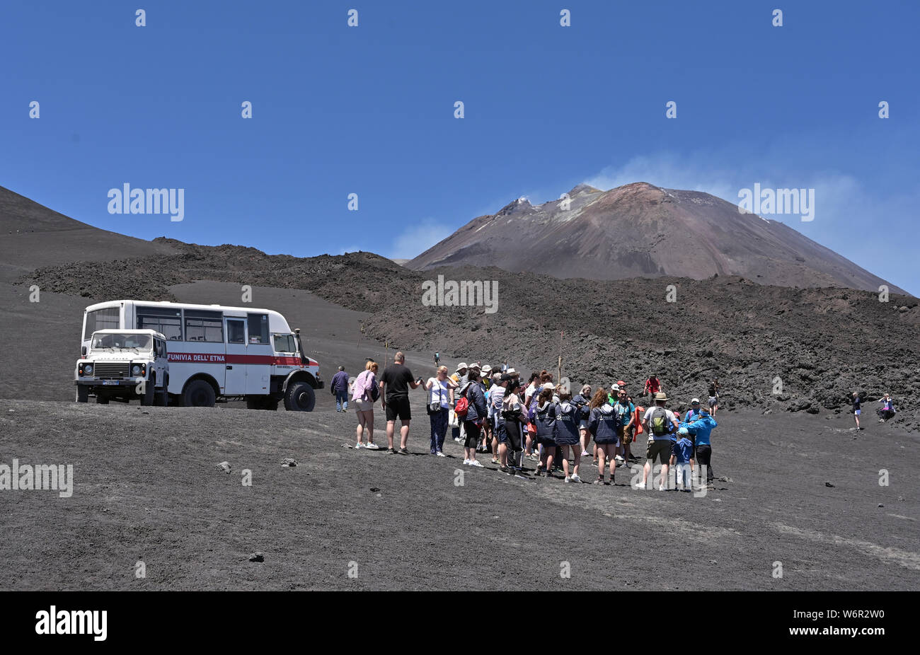 Tourists walking up Mount Etna an active volcano on the east coast of  Sicily, Italy Stock Photo - Alamy