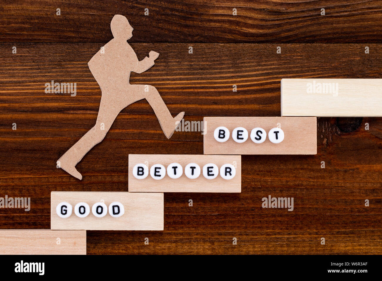 Good - Better - Best, paper man climbing the steps to success in a ...