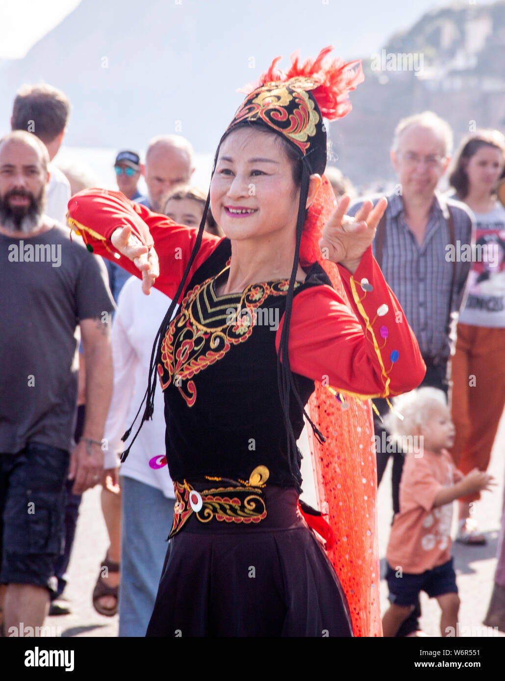 Sidmouth, Devon. 2nd Aug 2019. UK Weather: Far Eastern dance display in glorious sunshine on the Esplanade as Sidmouth Folk Week gets under way. Credit: Photo Central/Alamy Live News Stock Photo