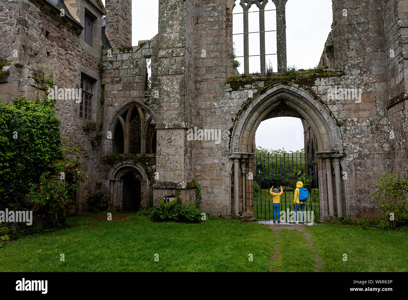 Mother and son standing in front of the ruins of the abbey of Beauport in Paimpol, Brittany, France Stock Photo