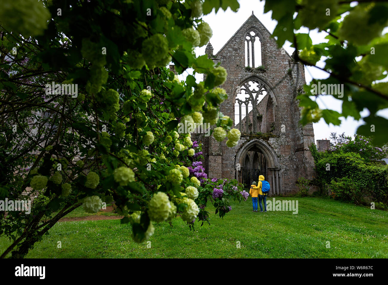 Mother and son standing in front of the ruins of the abbey of Beauport in Paimpol, Brittany, France Stock Photo