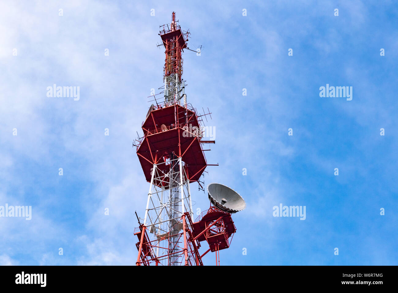 4G TV radio tower with parabolic antenna and satellite dish. Broadcast network signal. High