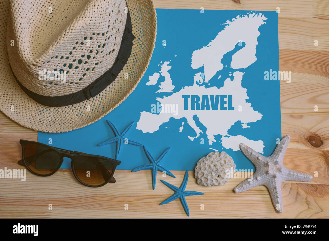 Go travel! Hat sunglasses and europe map with pin a on a wooden table. Top view Stock Photo