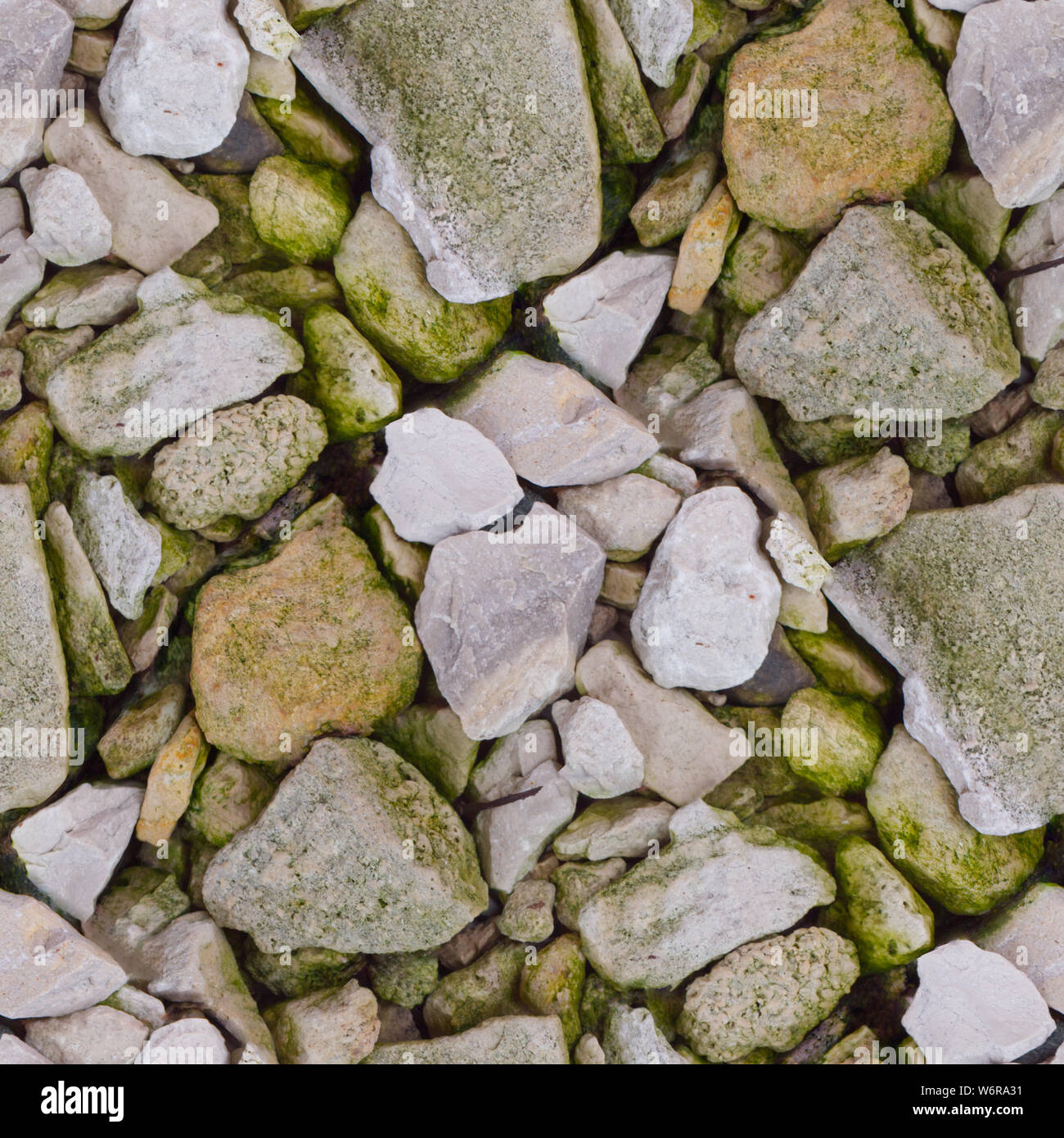 Abstract seamless photo pattern for designers or developers. Various broken rocks with moss fragments and rust. Stock Photo