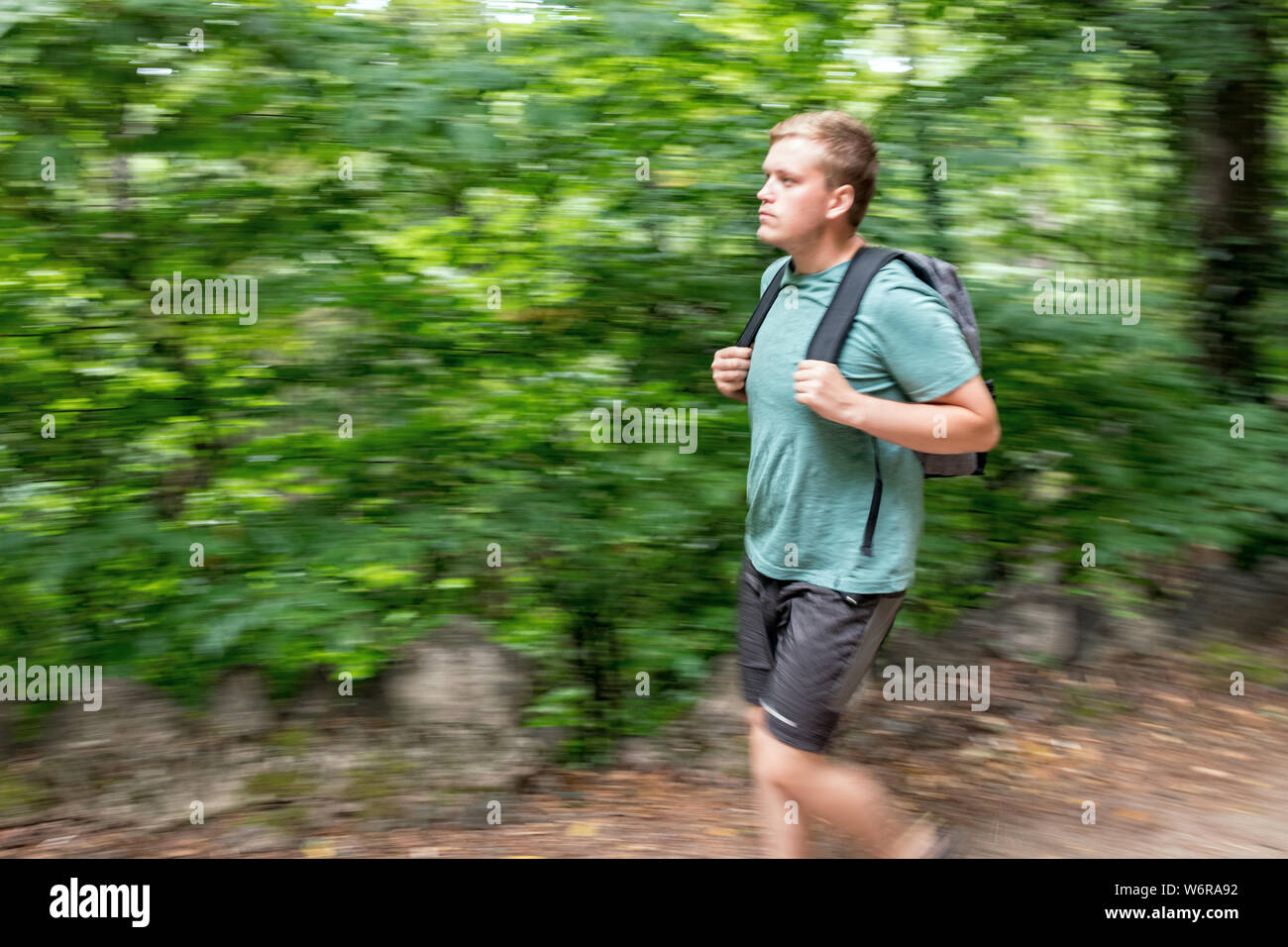 Hiking man portrait with backpack walking in nature Stock Photo - Alamy