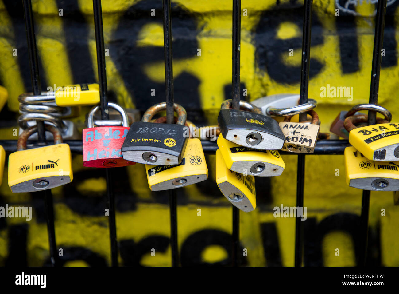 Castles of love at a fence, at Signal-Iduna-Park, Westfalenstadion, football stadium of BVB Borussia Dortmund, in black-yellow club colours, Stock Photo