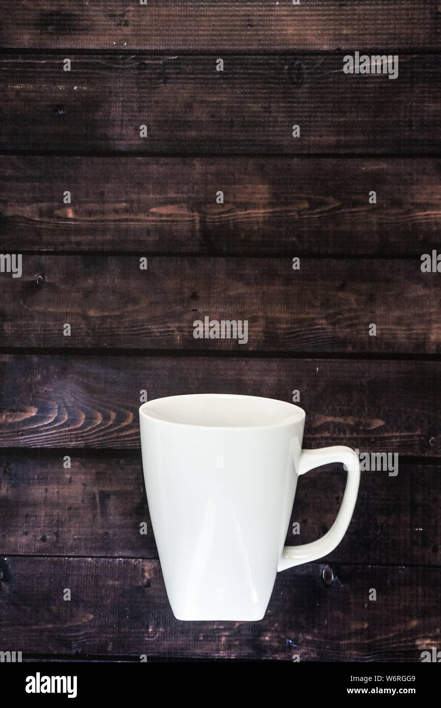 Close-up of three take away green paper cups in coffee holder container  with coffee beans and hot chocolate drink on rustic wooden table  background, top view, Stock Photo