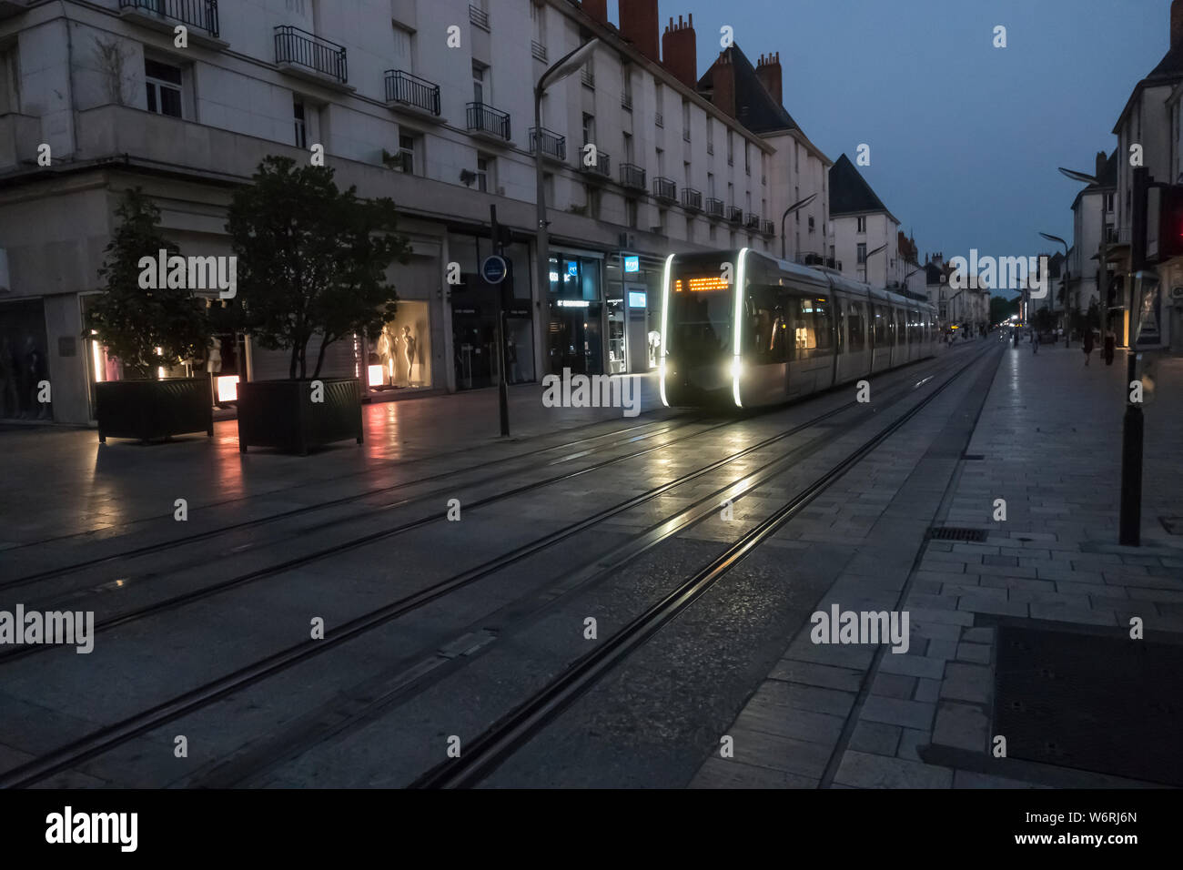 Tours, France sleek tram at night, catenary-free, using underground power in city center. Alstom Citadis 402 cars light rail service began 2013 Stock Photo