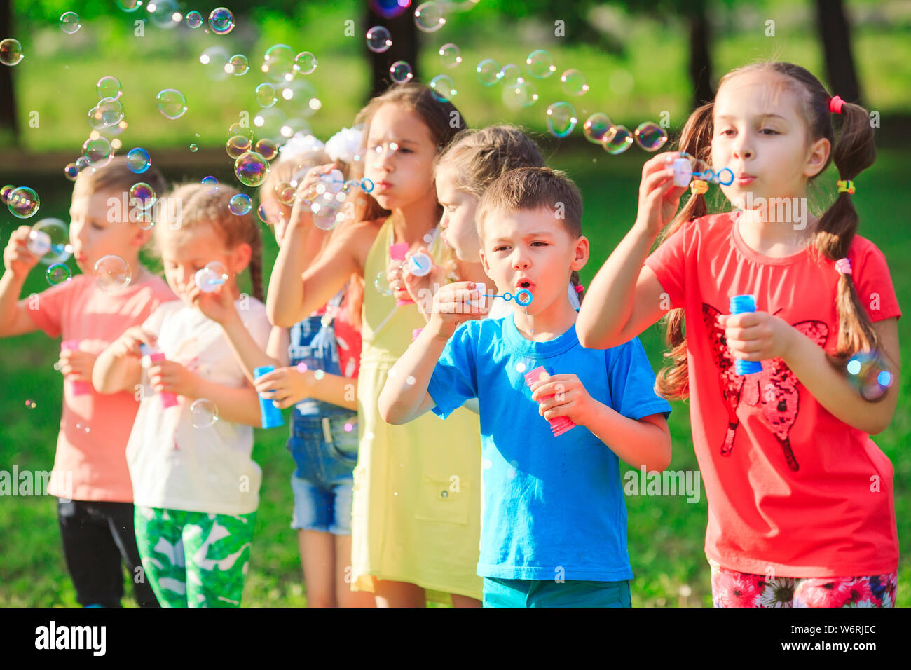 The Group Of Children Blowing Soap Bubbles Stock Photo Alamy
