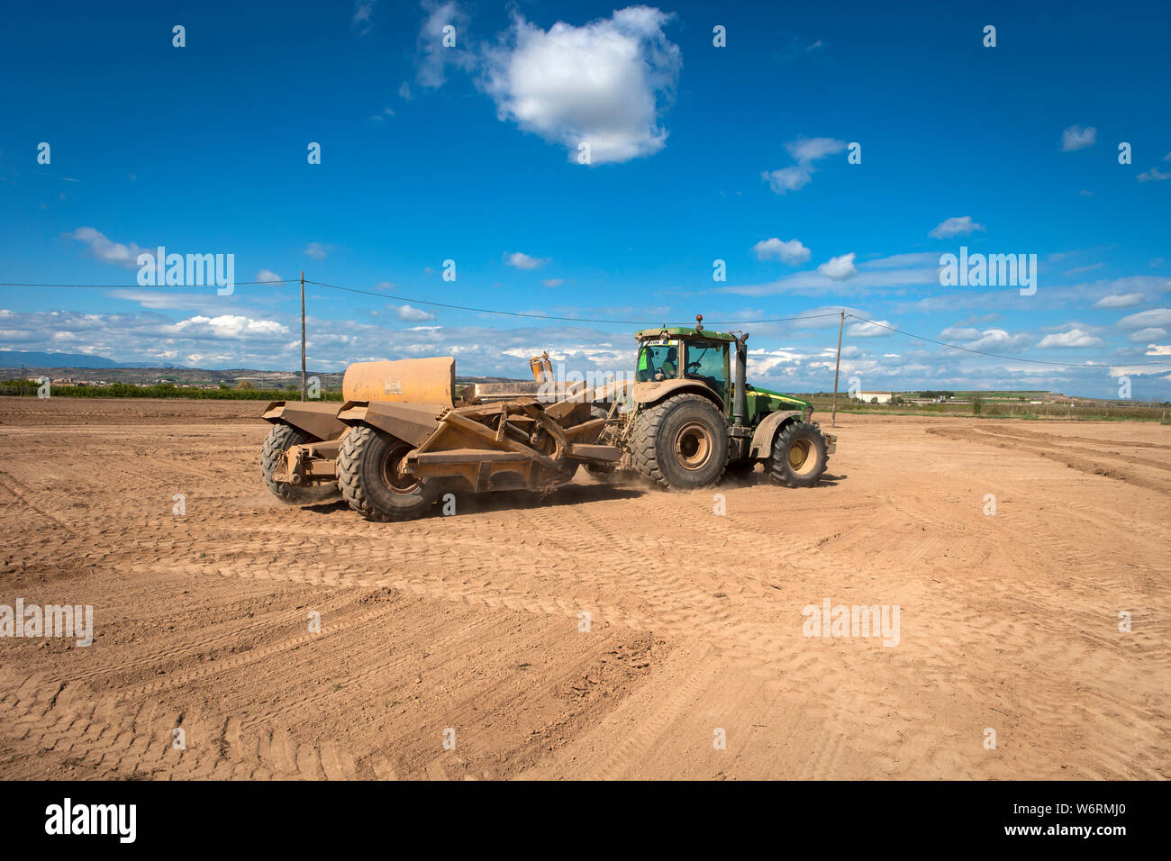 Tractors leveling in the field Stock Photo Alamy