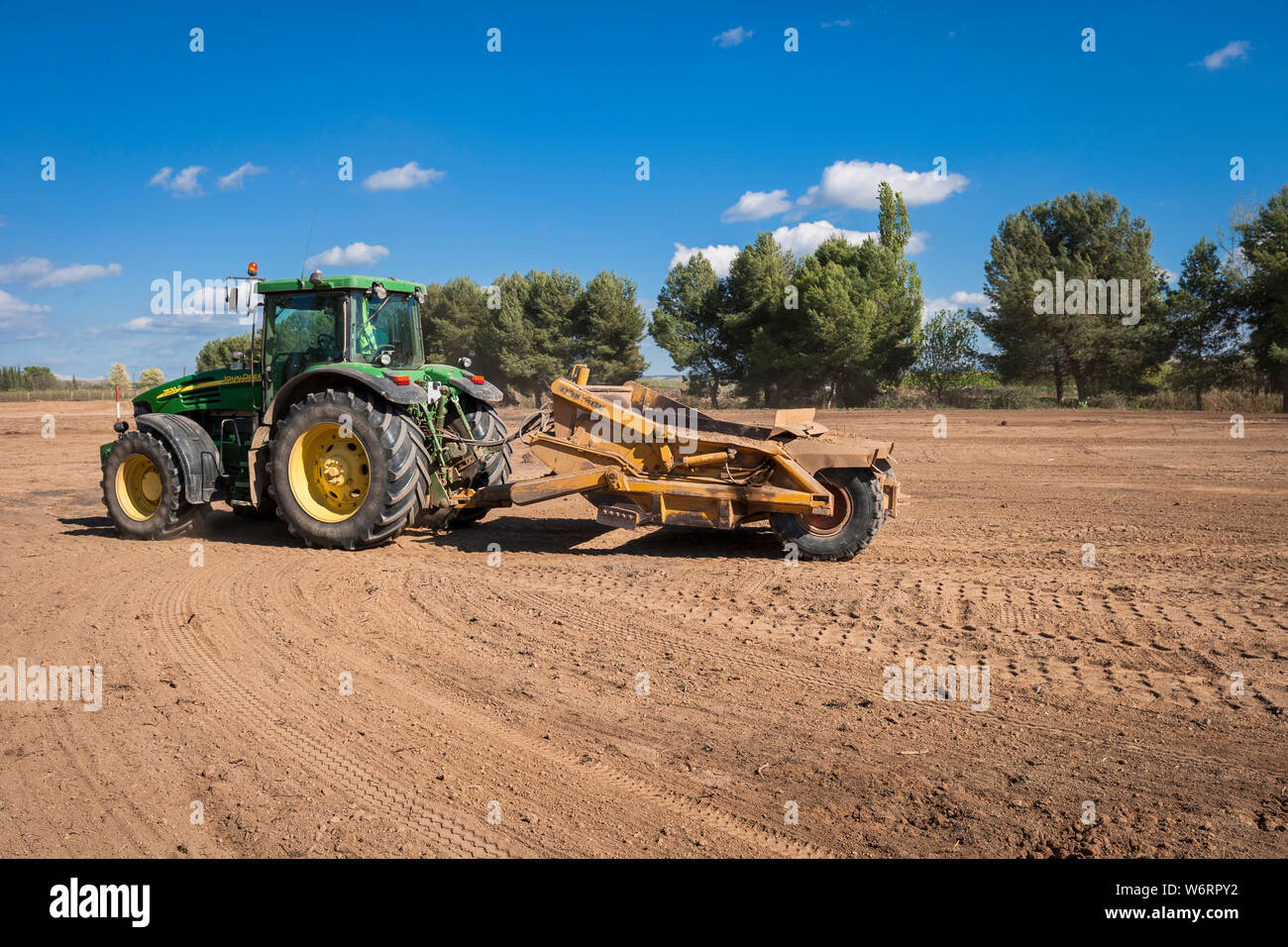 Tractors leveling in the field Stock Photo Alamy
