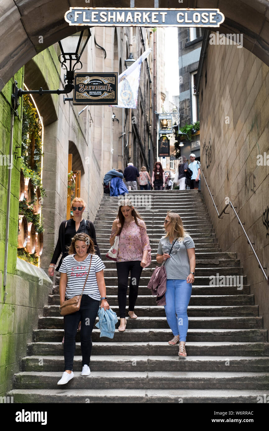A group of women walking down Fleshmarket Close in Edinburgh's historic