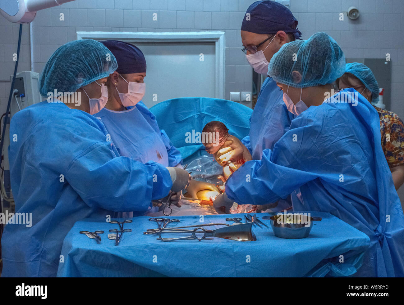 New life, baby being born via Caesarean Section in the operating room. Stock Photo