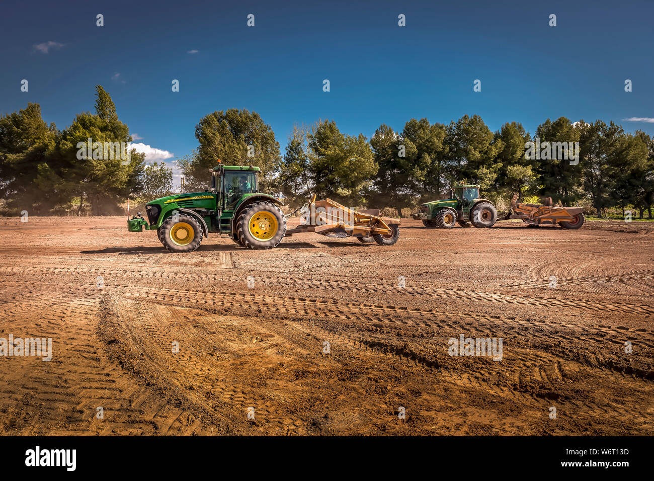 Tractors leveling in the field Stock Photo Alamy