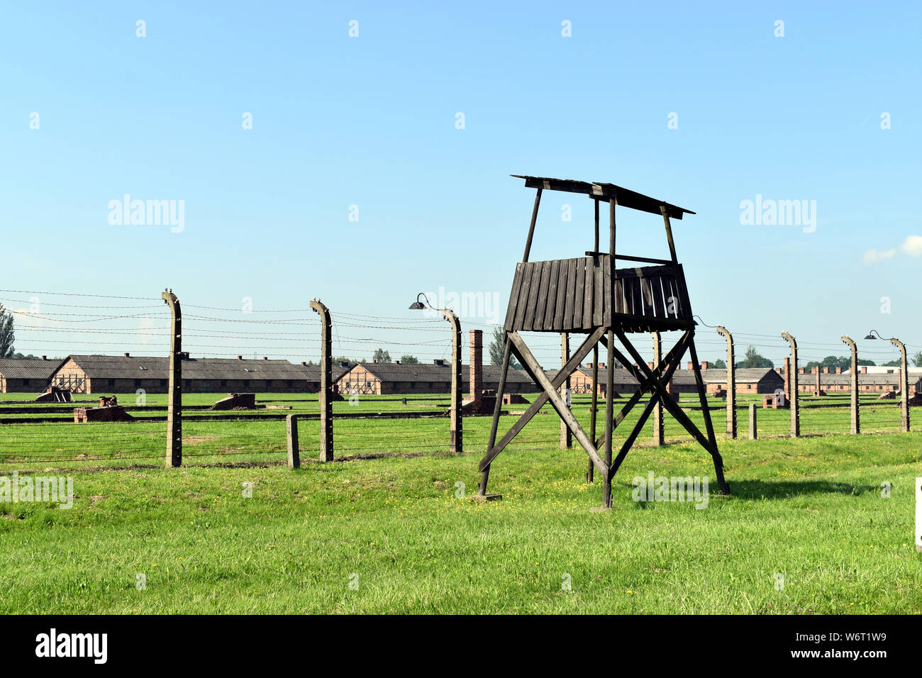 A general view of the accommodation buildings and a control tower at the Birkenau Concentration Camp in Poland Stock Photo