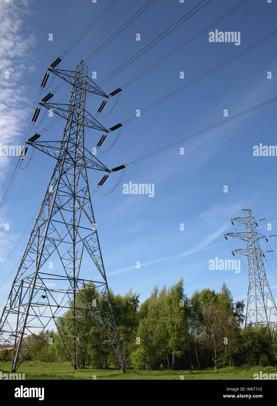 Electricity pylons against a blue sky Stock Photo - Alamy