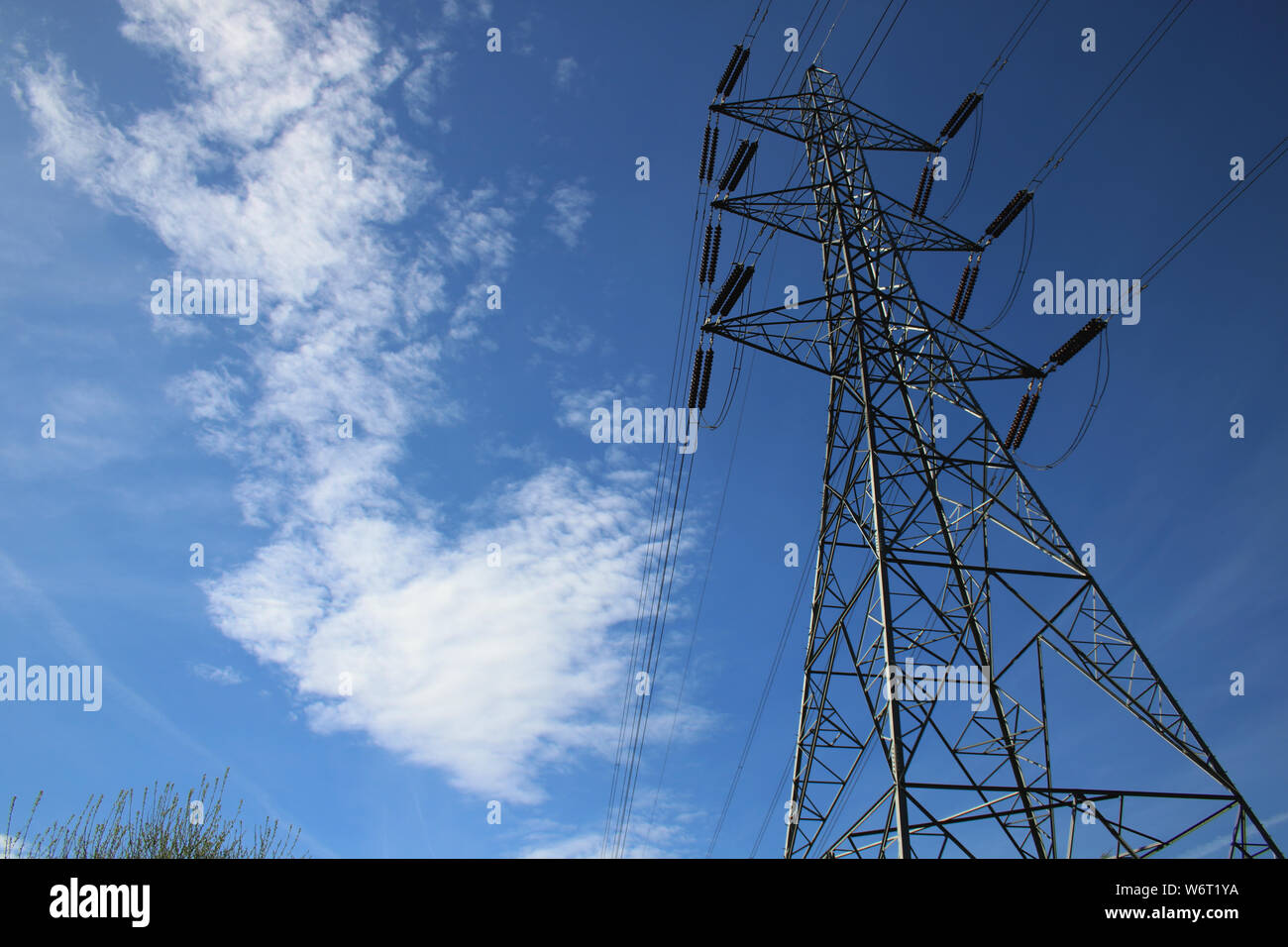 Electricity pylons against a blue sky Stock Photo - Alamy