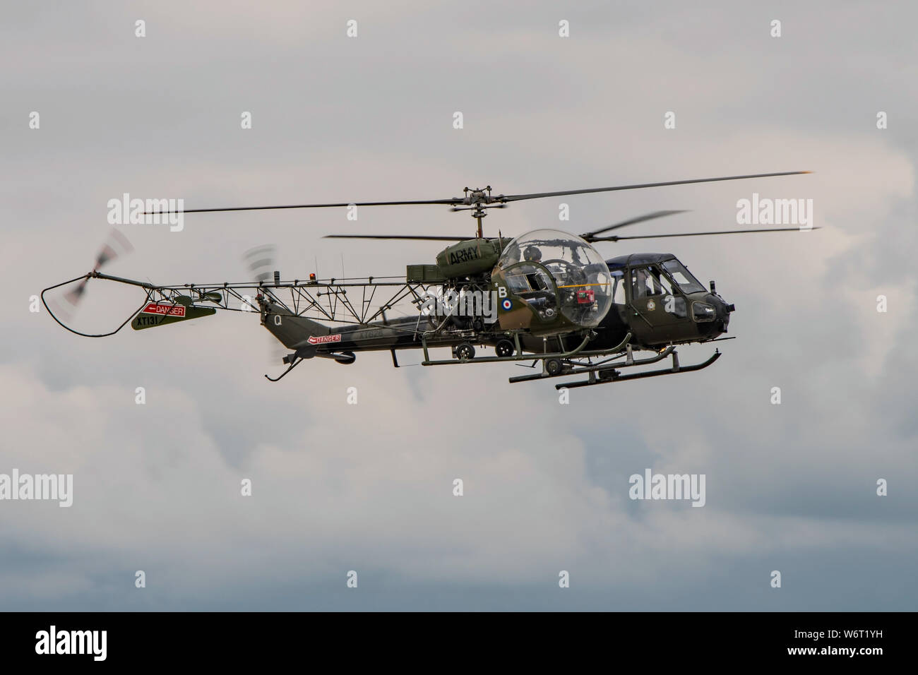 Two vintage British Army helicopters from the Historic Army Aircraft Flight flying in close formation at the RNAS Yeovilton, UK Air Day on 13/7/19. Stock Photo