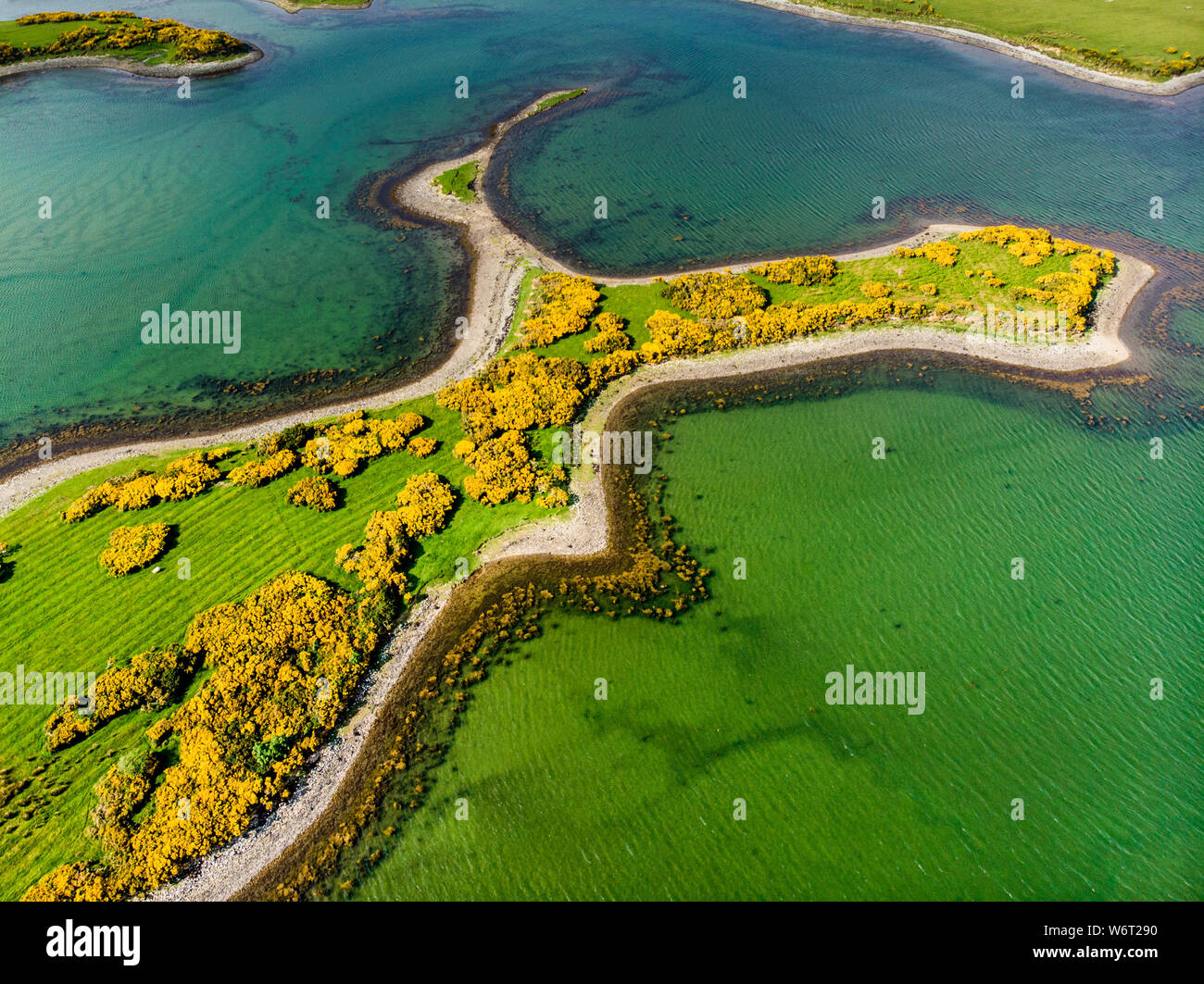 Aerial view of vivid emerald-green waters and small islands near ...