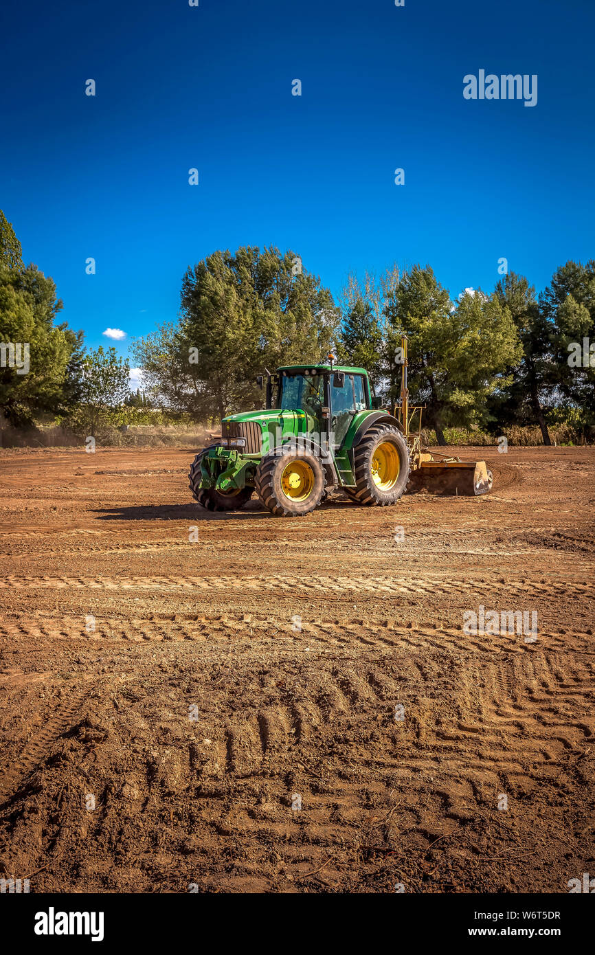 Tractors leveling in the field Stock Photo Alamy