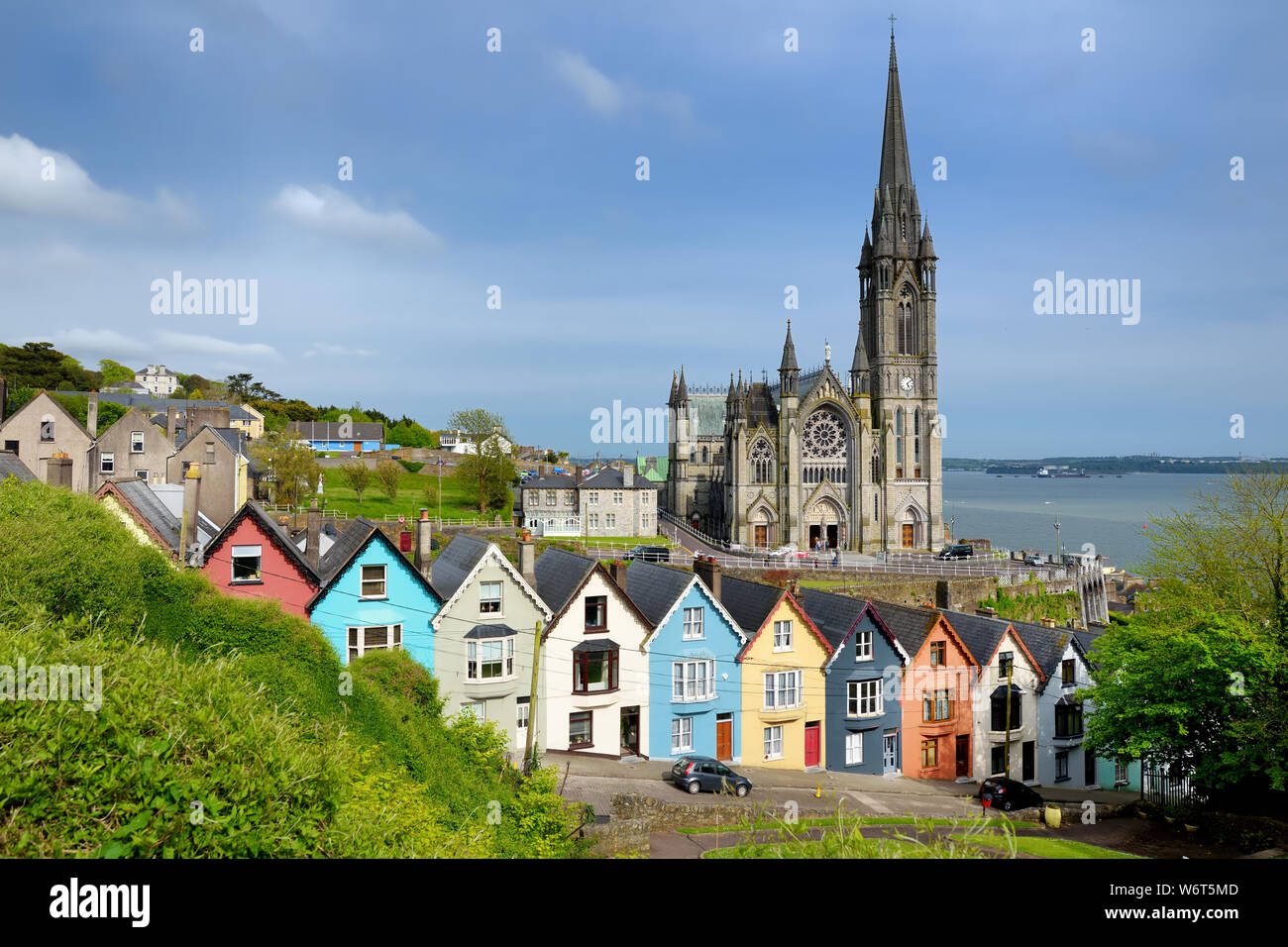 Colorful row houses with towering St. Colman's Cathedral in background