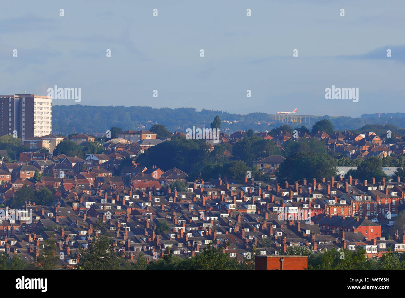 The view of Leeds Bradford Airport runway with a Jet 2 aircraft about to depart. Taken from a 125 foot work platform in Armley which is 5 mile away. Stock Photo