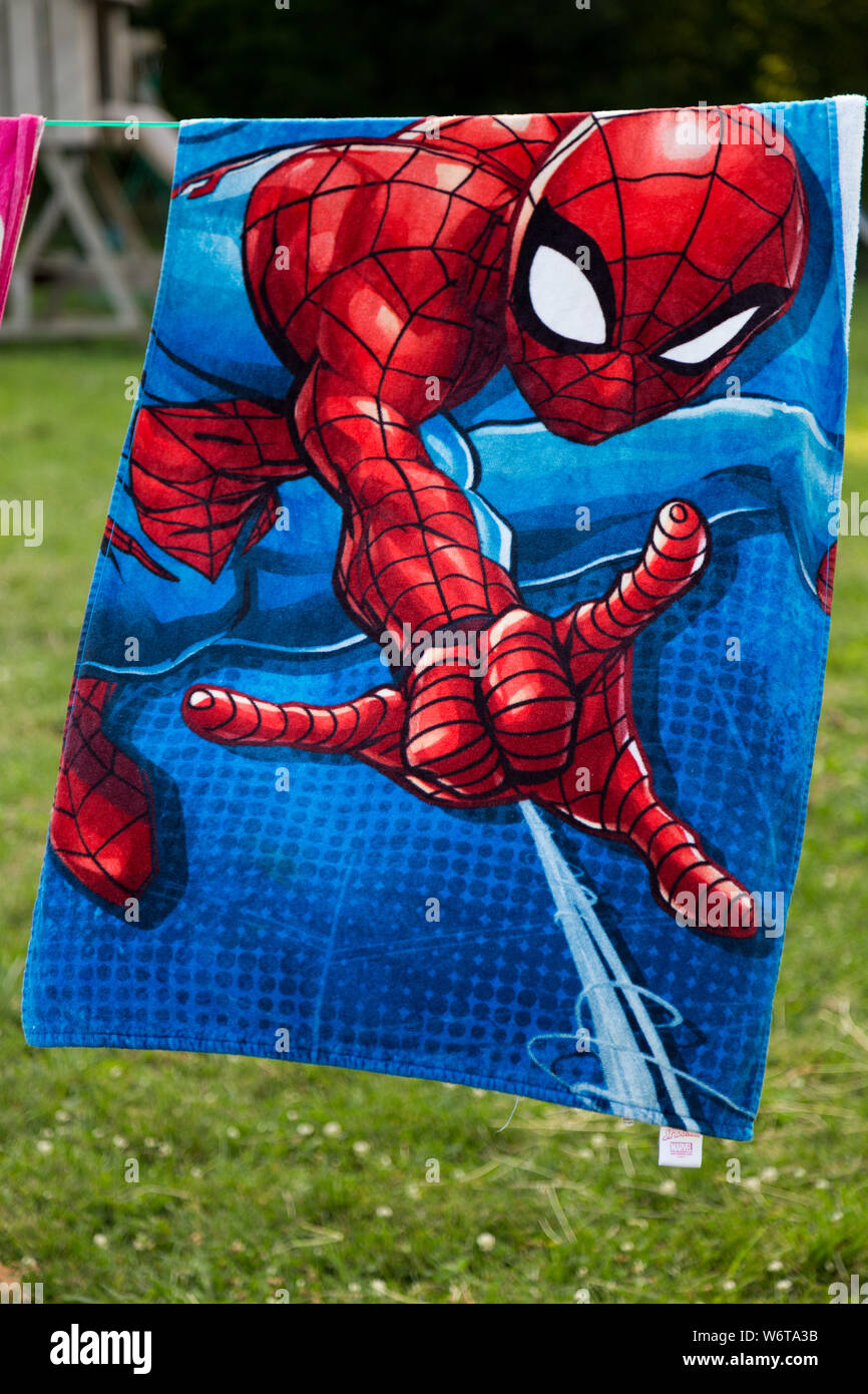 A Spider-Man beach towel hangs on a clothesline in a DeKalb County farmyard near Spencerville, Indiana, USA. Stock Photo