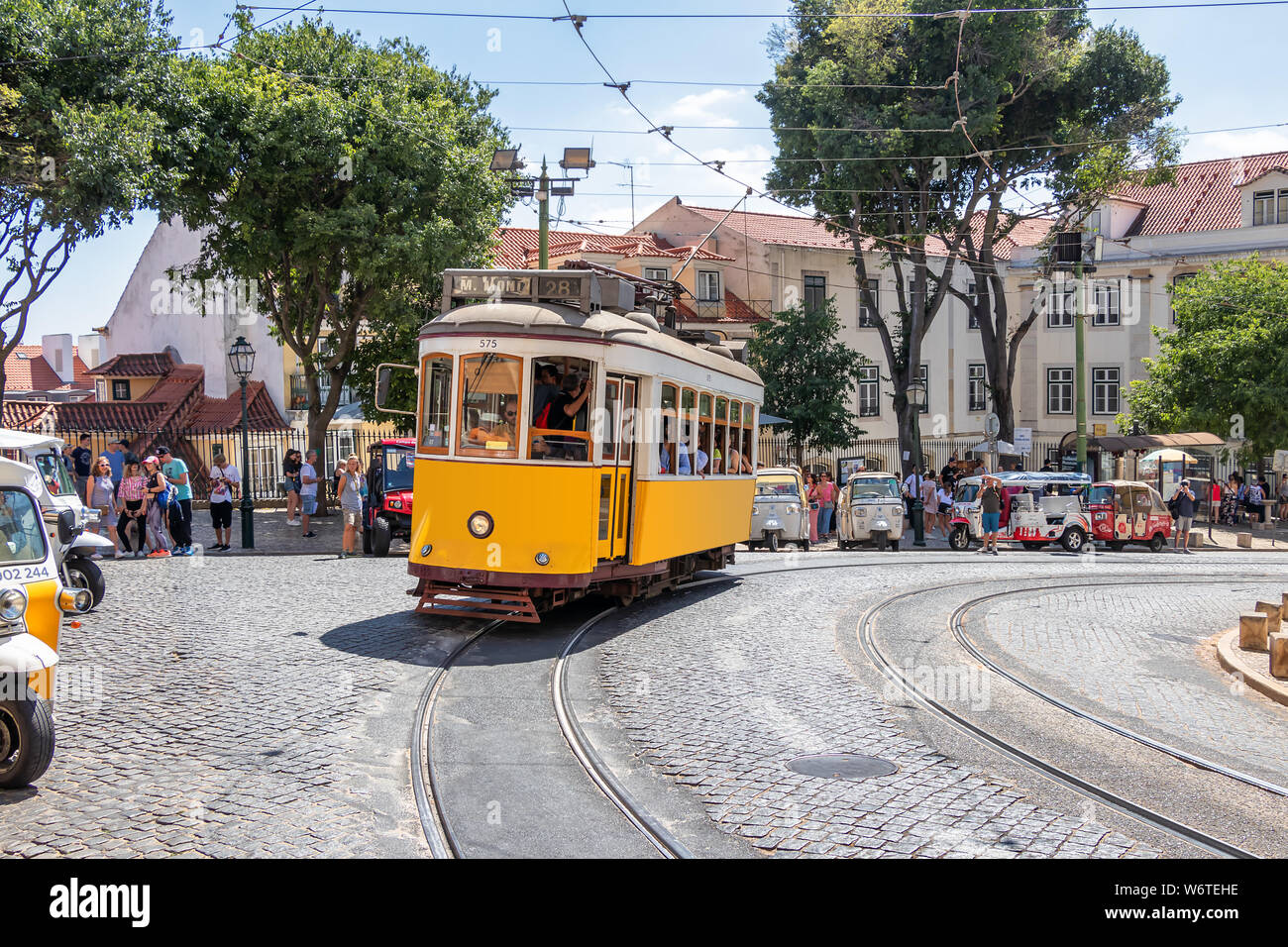 The famous yellow tram 28 passing in front of Santa Maria cathedral in
