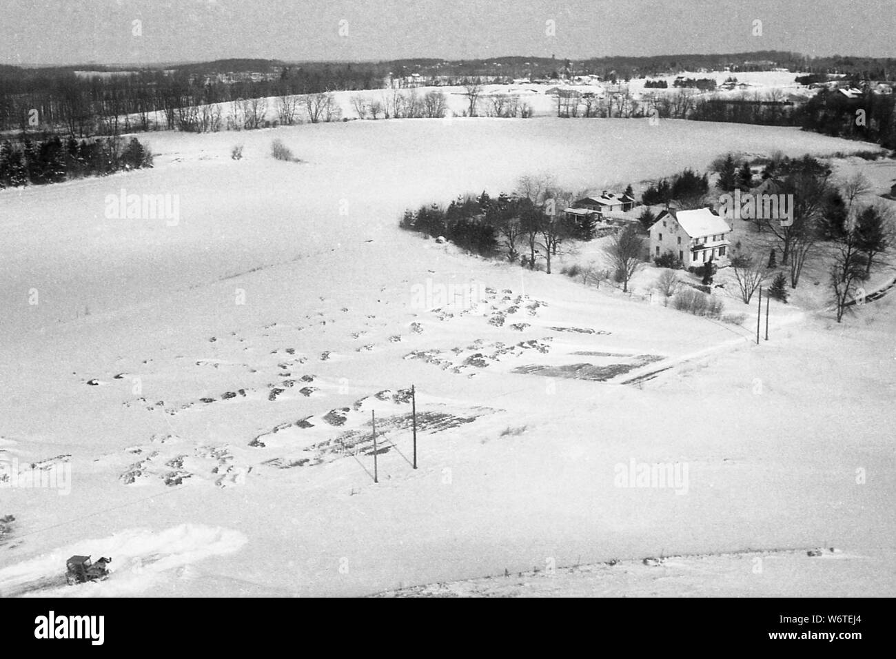 Aerial after snow storm digs out road to get to the farmhouse in Bucks ...