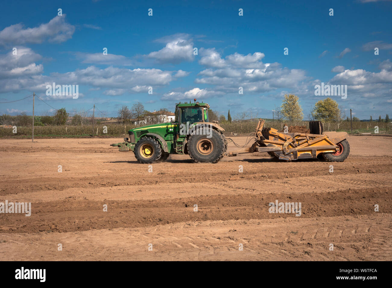 Tractors leveling in the field Stock Photo Alamy