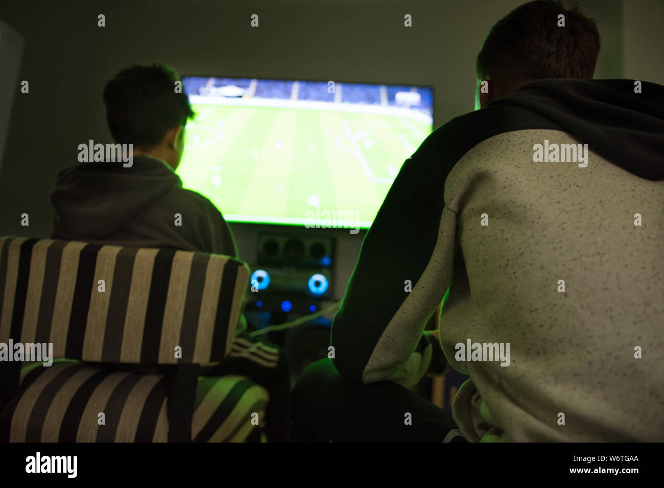 Two teenagers playing video game Stock Photo